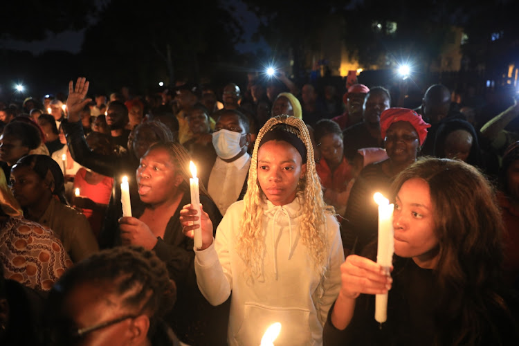 Bereaved family members during a sombre memorial service to remember the 27 people who died in the gas tanker explosion.