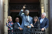 The statue of Nelson Mandela on the balcony at Cape Town City Hall after its unveiling by‚ (from left)‚ Western Cape Premier Helen Zille‚ Nelson Mandela Foundation chairman Njabulo Ndebele‚ Cape Town mayor Patricia de Lille and Western Cape tourism and economic opportunities MEC Alan Winde on July 24 2018 