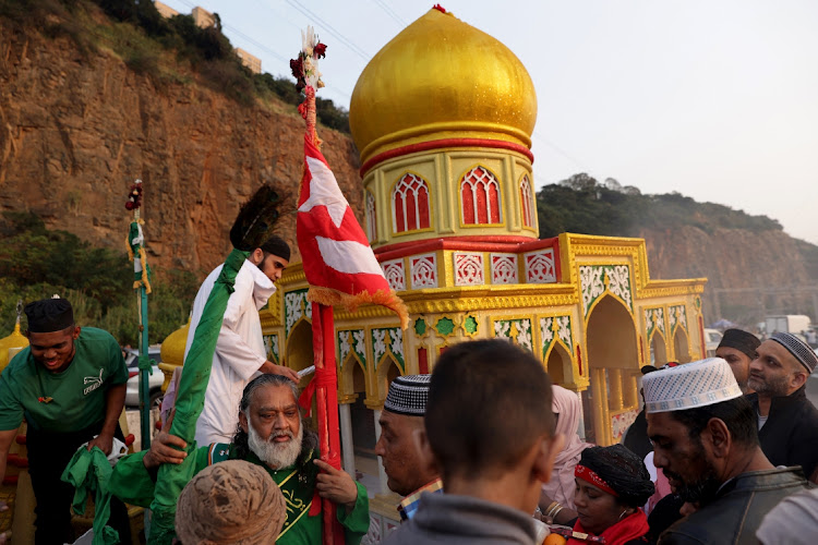 Ridwaan Ismail blesses people during the Islamic Holy Day celebrations in Springfield.