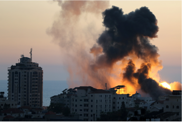 Smoke and flame rise during Israeli air strikes, as cross-border violence between the Israeli military and Palestinian militants continues, in Gaza City, on May 14 2021.