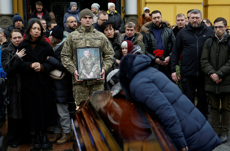 Natalia Holub reacts over the coffin holding the body of her son Volodymyr Yezhov, a Ukrainian serviceman and game designer for the world-renowned games, 'S.T.A.L.K.E.R.' and 'Cossacks', in Kyiv. Yezhov was recently killed in a fight against Russian troops near the town of Bakhmut, Picture: REUTERS/VALENTYN OGIRENKO