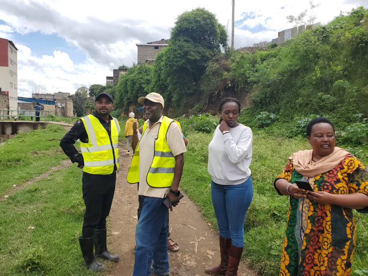 Narok executive member in charge of Roads and Public works John Gatua with water engineers inspecting water ways in Narok town.