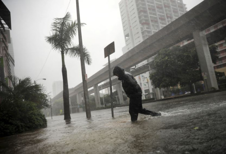 A local resident walks across a flooded street in downtown Miami as Hurricane Irma arrives at south Florida, US September 10, 2017.