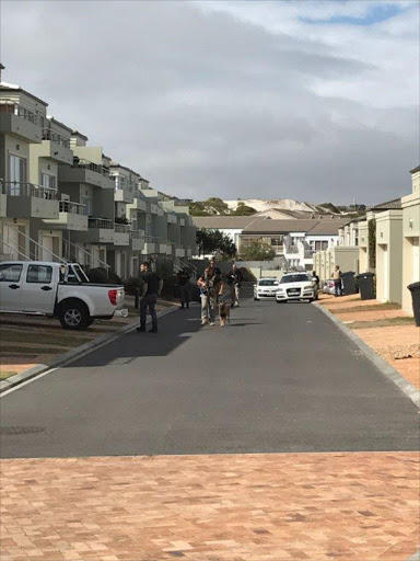 Police search the Benguela Beach residential complex.