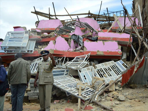 Kakamega County police Commander Johanah Tunoi at the collapsed house in Kakamega's Juakali area .The house is said to have been build hastily without observing building and construction technical requirements./ CALISTUS LUCHETU