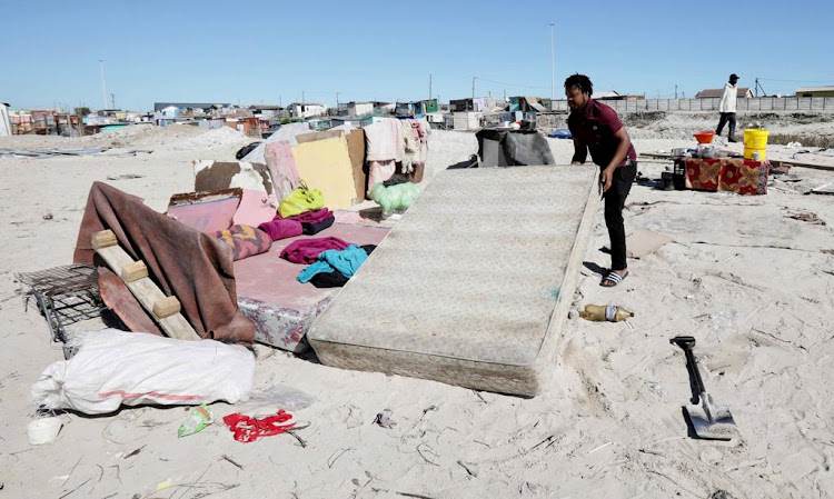 One of the 49 householders allowed to return to the Empolweni land piles up his belongings on April 20 2020.