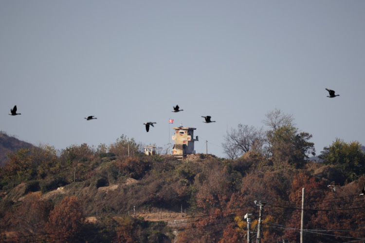 Birds fly over a North Korean guard post in this picture taken near the demilitarized zone separating the two Koreas, in Paju, South Korea, November 4 2022. Picture: REUTERS/KIM HONG-JI