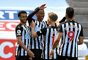 Joe Willock, arms raised, celebrates his last-gasp winner for Newcastle against high-flyers West Ham yesterday.