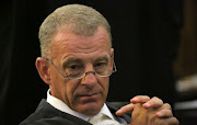 Gerrie Nel said he was astounded that someone accused of killing his wife with a firearm was given a firearm by the SAPS.