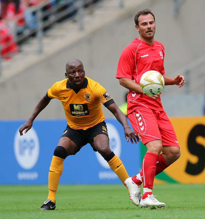 Patrik Berger of Liverpool passes the ball from Ntsie Maphike during the Legends match between Liverpool FC Legends and Kaizer Chiefs Legends at Moses Mabhida Stadium on November 16, 2013 in Durban, South Africa.