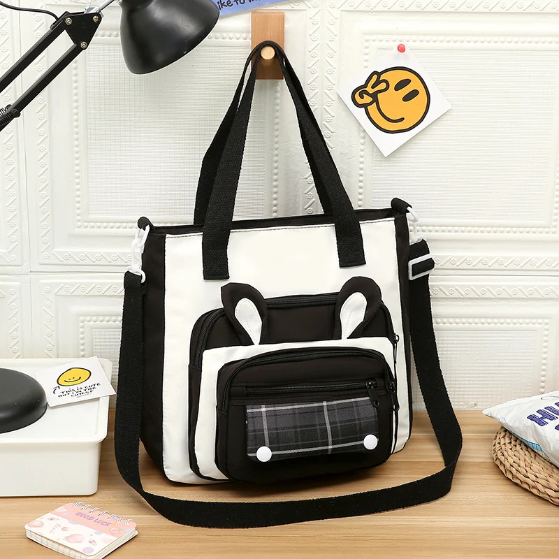 Sac bandoulière en toile imperméable, grande capacité et motif dessin animé, pratique et portable pour transporter vos essentiels.