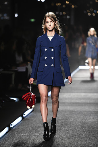 A model rocks a sixties-inspired look on the runway for Louis Vuitton.