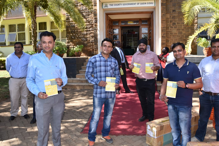 Members of the Hindu community at the Uasin Gishu county offices in Eldoret where they donated water tanks and sanitiser to support war against spread of the coronavirus.