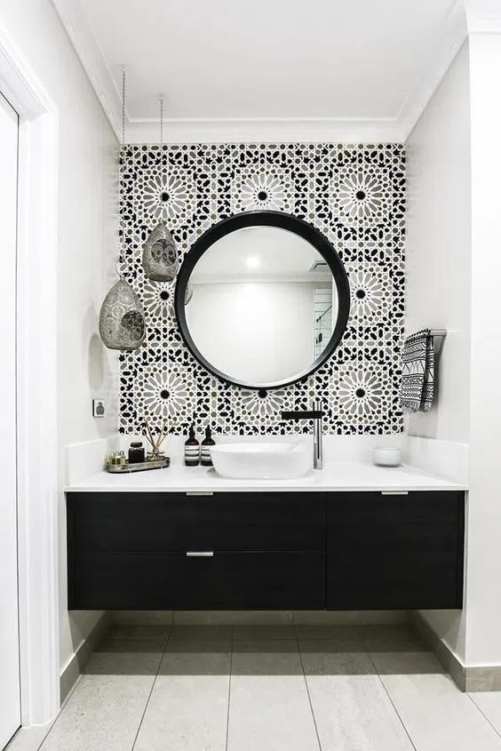 black and white contemporary bathroom with patterned wallpaper, black vanity, tile floors, white wall paint and modern white sink