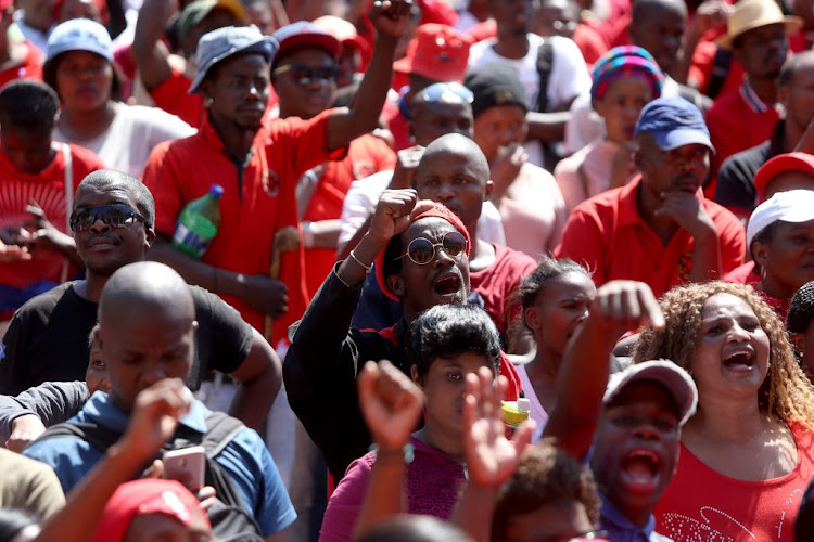 Abahlali baseMjondolo members march to the Durban City Hall in October 2018 to hand over a memorandum of demands. The movement has accused the ANC of mobilising hitmen, the anti-land invasion unit, municipal security guards and two police forces against it.