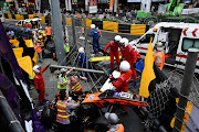 Race personnel and pit crew at the accident site after Sophia Floersch, a German driver of Van Amersfoort Racing flew over the barriers and crashed into a photographers' bunker at high speed during a Formula Three race at the Macau Grand Prix in Macau, China on Sunday.