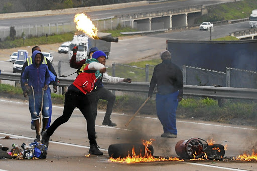 Zuma supporters block the N3 at Peacevale, on the outskirts of Durban, as violence erupted over the jailing of the former president.