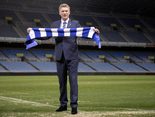Real Sociedad's new coach David Moyes poses with a scarf of his new club during his official presentation at the Anoeta stadium in San Sebastian on November 13, 2014. Former Manchester United manager David Moyes said today he turned down offers from several English clubs when he opted for the challenge of leading Spanish league stragglers Real Sociedad.
