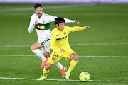 Takefusa Kubo of Villarreal  is put under pressure by Fidel of Elche  during the La Liga Santander match between Villarreal CF and Elche CF.