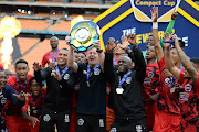 Warriors coach Dylan Kerr and players celebrates during the DStv Compact Cup final match between Coastal United and Warriors at FNB Stadium on January 29, 2022 in Johannesburg, South Africa. 