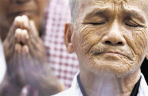 Bou Meng, a survivor of the Khmer Rouge regime, cries at Choeung Ek 'Killing Fields' on the outskirts of Phnom Penh. File photo.