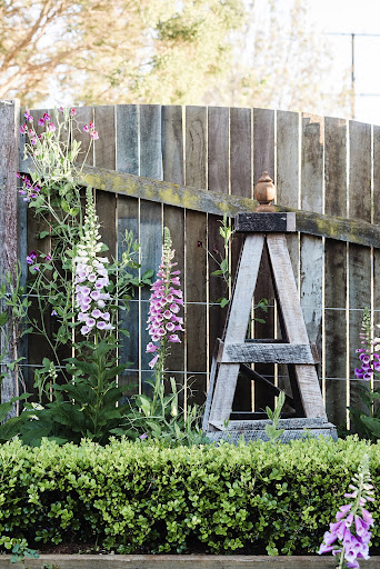 An obelisk made from reclaimed timber surrounded by Fox Gloves.