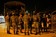 Members of the military gather outside of the Penitenciaria del Litoral, one of Ecuador's largest prisons, after prisoners died in a riot, in Guayaquil, Ecuador on September 29, 2021. 