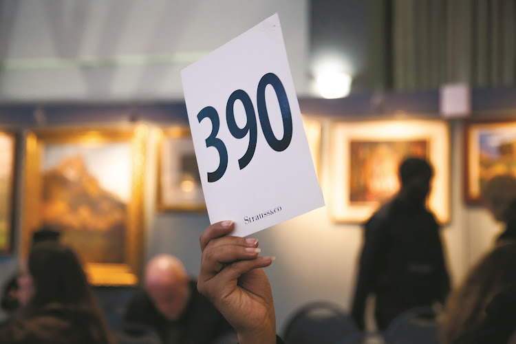 Bidding at a live art auction.