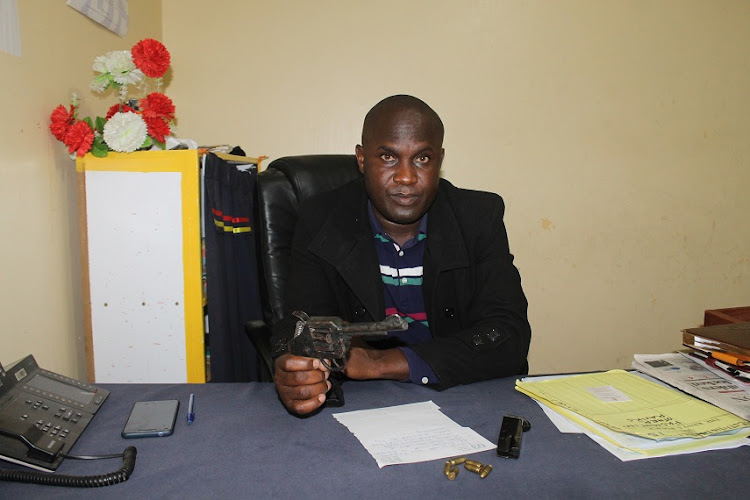 Athi River police commander Samwel Mukuusi displays a home-made gun recovered from a suspect on Thursday night.