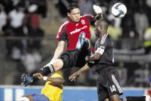 ANIOUS MOMENT: Bucs Moeneeb Josephs and Lucky Lekgwathi at sixes and sevens against Katlego Mphela during Sundowns 2-0 win at Atteredgeville Stadium last night. Pic: ANTONIO MUCHAVE. 25/11/2009. © Sowetan.