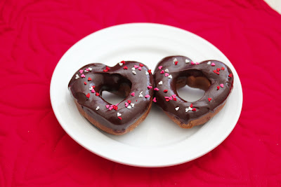 overhead photo of two heart-shaped chocolate donuts on a plate