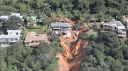 A ravine opened beneath this house in Umdloti, north of Durban, one of the hardest-hit towns, in flooding on April 12 2022.  The KwaZulu-Natal premier says 341 people have died in the floods.