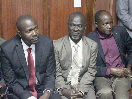 Michael Oyamo, Migori Governor Okoth Obado and Casper Obiero at Milimani law courts on February 14. /COLLINS KWEYU