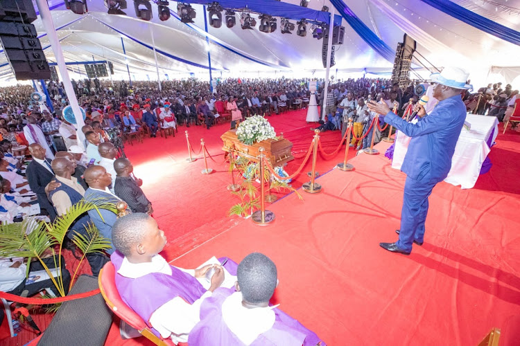 ODM party leader RAila Odinga addressing mourners during the burial of former Education Cabinet Secretary George Magoha on February 11, 2023.