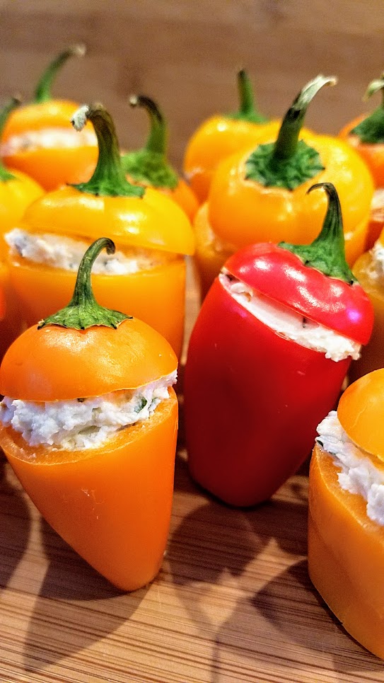 Recipe for Cheese Stuffed Mini Peppers, easy peasy and are adorable because of the way you can get multiple colors with the orange, yellow and red which are so cheerful, and then presentation wise the way they stand up in little rows or formations so bravely