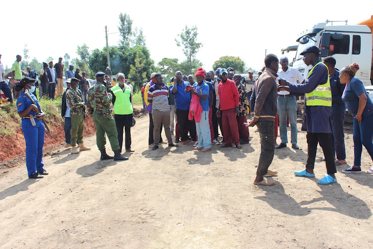 Motorists and boda boda riders at Mahua-ini area where the road had been blocked to allow for construction of the road.