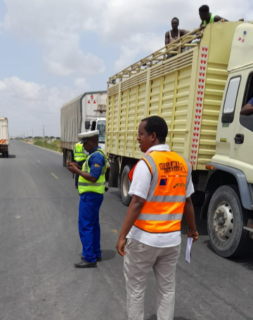 A police officer and NTSA officer during the road safety compliance checks along the Garissa - Nairobi highway, March 27, 2024.