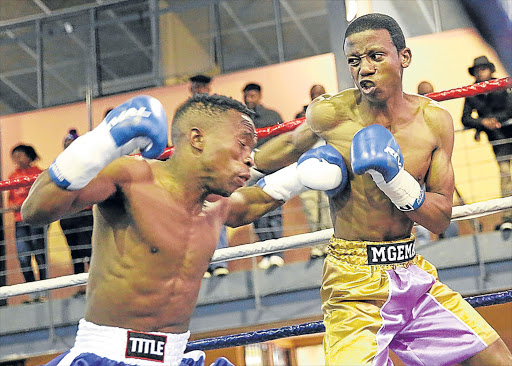 TOO MUCH RING CLASS: In what can only be described as a mismatch, Mthatha’s Siphamanlda Baleni, in blue, inflicted so much damage to Mdantsane’s Iviwe Mgema, in purple, at the Indoor Centre on Sunday, his trainers threw in the towel on round four Picture: MARK ANDREWS