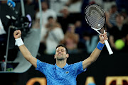 Novak Djokovic of Serbia celebrates to the crowd after his victory in their round one singles match against Roberto Carballes Baena of Spain during day two of the 2023 Australian Open at Melbourne Park on January 17, 2023 in Melbourne, Australia.  