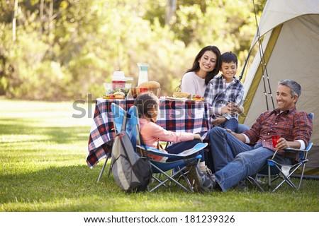 Family Enjoying Camping Holiday In Countryside