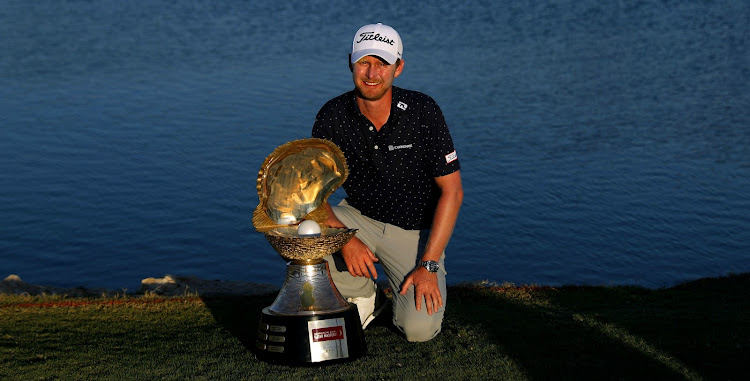 Justin Harding of South Africa poses with the winner's trophy after winning the Commercial Bank Qatar Masters at Doha Golf Club on March 10, 2019 in Doha, Qatar.