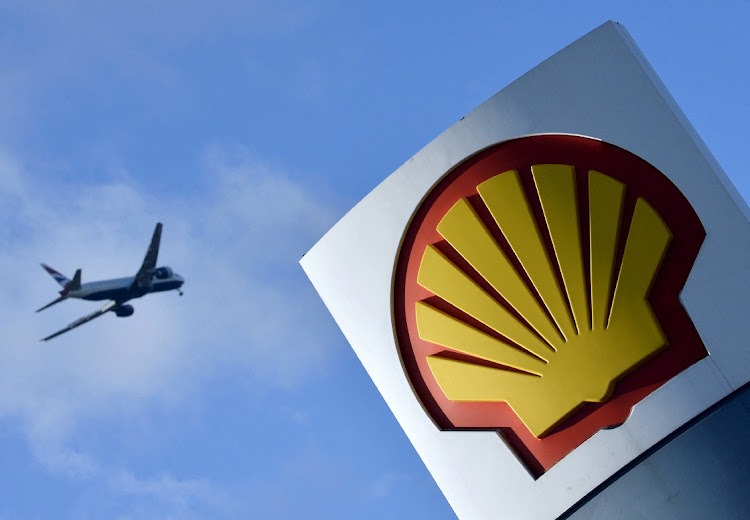 A passenger plane flies over a Shell logo at a petrol station in west London on January 29 2015. File Picture: REUTERS/Toby Melville