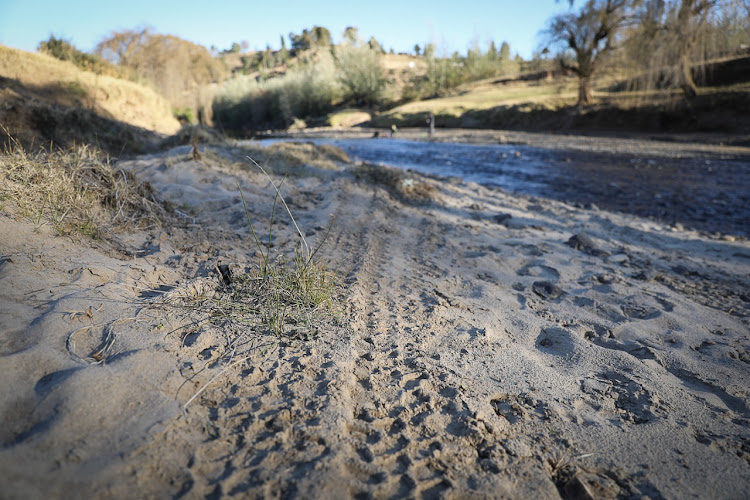 Vehicle tracks leading to the Caledon River that is used as a crossing from South Africa to Lesotho.