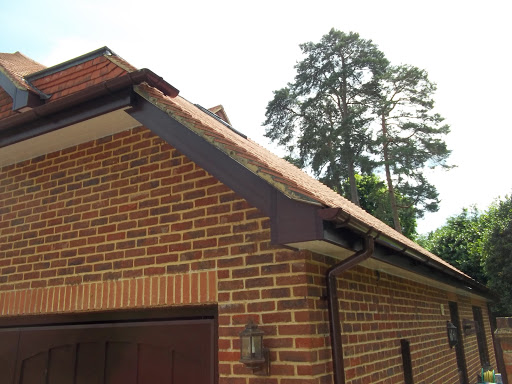 Rosewood fascia, white soffit, brown gutters, cement verge rebuilds