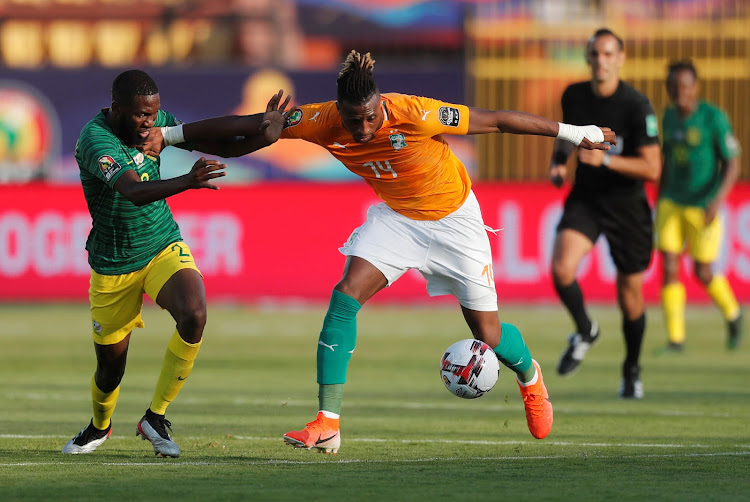 Ivory Coast's Jonathan Kodjia shrugs off South Africa's Buhle Mkhwanazi before firing home the only goal of the match during an Afcon Groud D encounter in Cairo on June 24 2019.