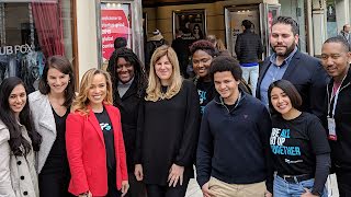 A group of ten people looking at camera