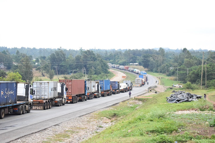 Cargo trucks along the Malaba-Webuye highway. The road is narrow.