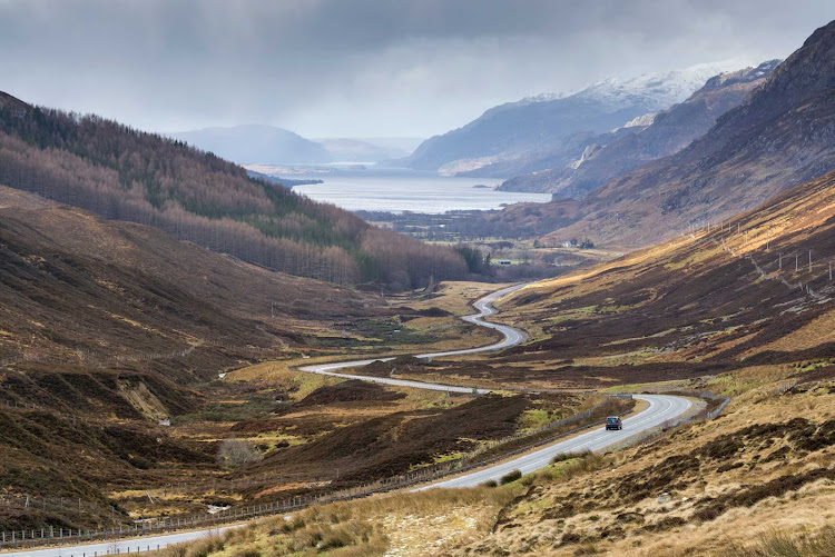 The road to Kinlochewe in the North Highlands of Scotland with Loch Maree in the distance.