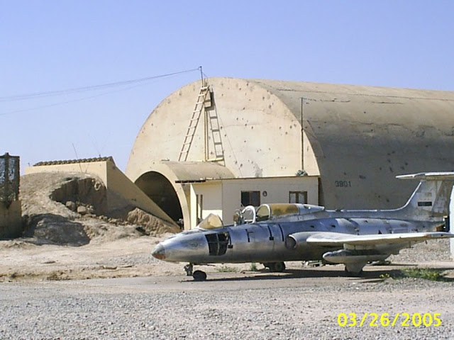 Old%20Iraq%20Jet%20Trainer%20and%20shot%20up%20hanger.jpg