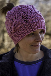 woman wearing pink ponytail hat knitting pattern outside